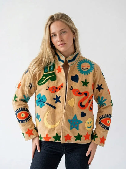 Woman wearing a colorful jacket with abstract patterns on a white background